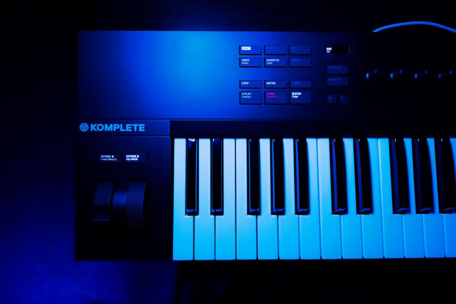 Close-up view of a synthesizer keyboard under dramatic blue lighting (Image Credit: XT7 Core - Pexels)