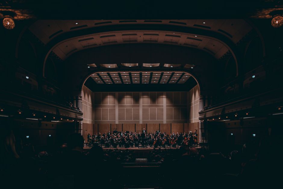Symphony orchestra performing live on a grand concert stage (Image Credit: King of Concepts - Pexels)
