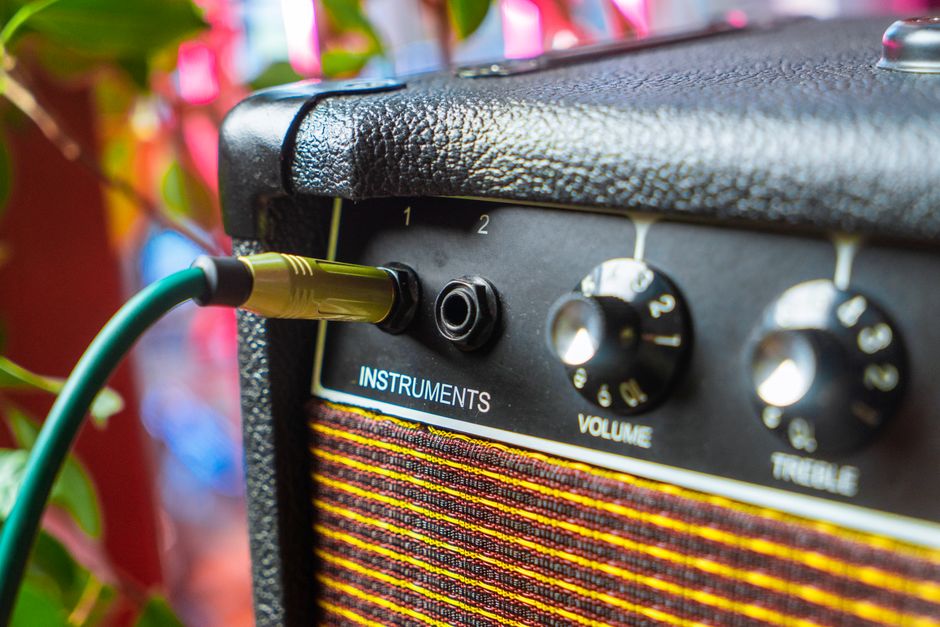 Close-up of an amplifier with an instrument cable plugged into the input jack (Image Credit: Alena Sharkova - Pexels)